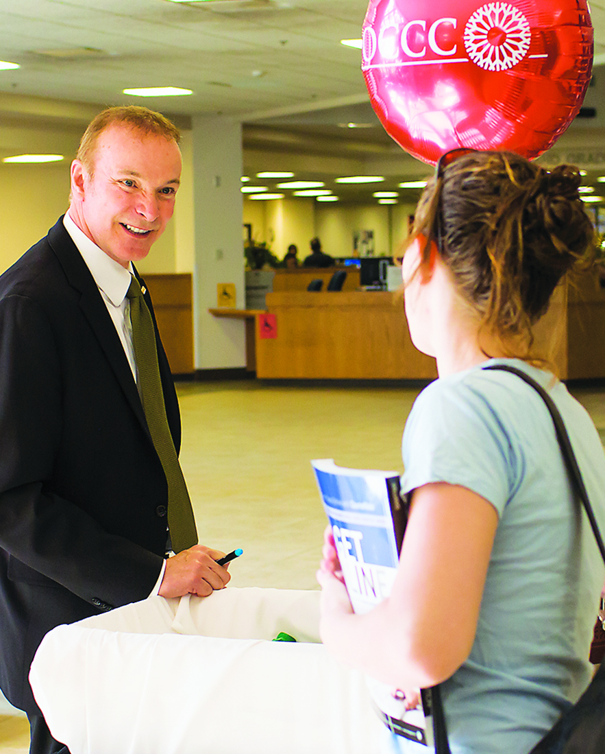 President Paul Sechrist helps students on first day of classes