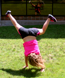 Amber, 7, does a cartwheel in the courtyard on June 24. She was taking part in the Musical Theater “Yee Haw!” class. Jake McMahon / Pioneer