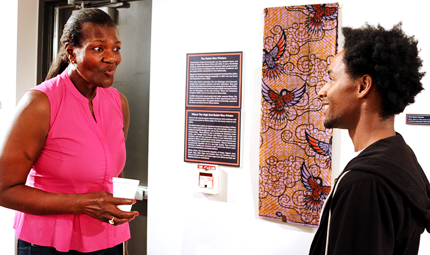 Gifty Benson explains African wax prints to a student
