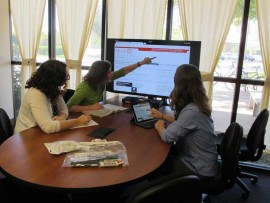 Students use genius board in library collaboration room.