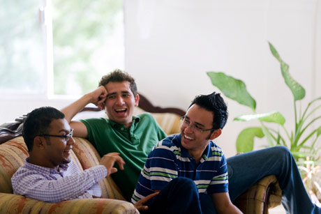 Roommates sitting together on a couch