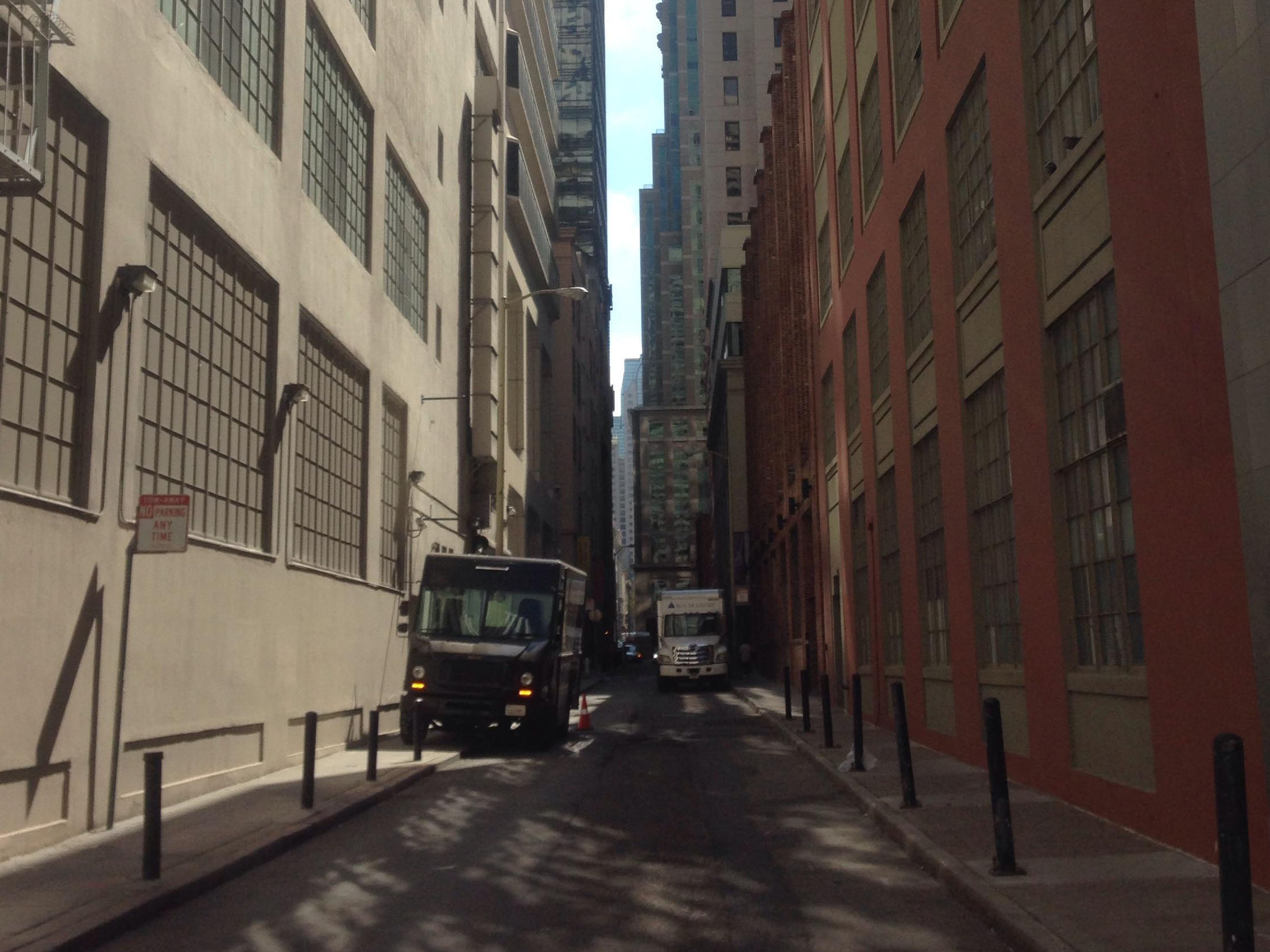A picture of an alley in a city.