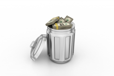 A picture of a large amount of money inside of a trashcan.