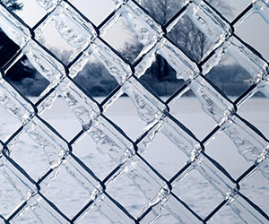 A picture of a frozen chain-link fence.