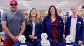 The Biology Lab recently received donated anatomical skulls from The Health Professions Club. From left to right: Caleb Hill, Health Professions Club President; Melissa Henkel, Senior Biology Lab Assistant; and Biology Lab Assistants Audri Malik and William Layden. Melissa Sue Lopez/Pioneer.