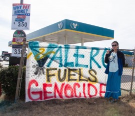 Ashley McCray, co-founder of group, No Plains Pipeline, stands next to "Valero Fuels Genocide" sign outside of Valero on I-240 and May on Wednesday, February 1st. This is the 3rd reported demonstration outside of Valero gas stations around the city in the past 2 days. “We will be doing this as long as necessary until we get the message across (about the Diamond Pipeline and Valero’s involvement in it)” said McCray. Photos by Aaron Cardenas