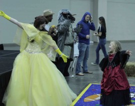 Woman dressed as Belle teaches a young girl the Time Warp from Rocky Horror Picture Show. Photo by Sean Stanley